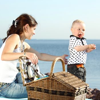 happy mother and son on picnic near sea