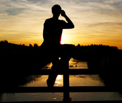 A person on a bridge making a photo