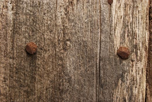 Old weathered wooden board, rusty nail's heads, as background