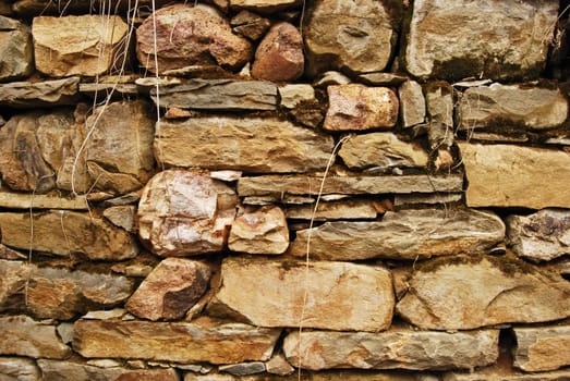 Old country structure stonewall, dry masonry, as background