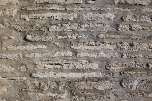 A grey and stained weathered brick wall, background.