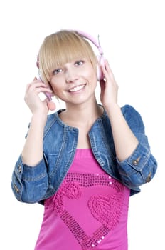 Young attractive woman listing to music with headphones against white background