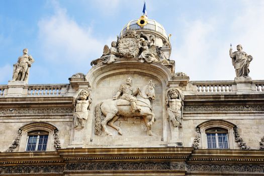 Architectural detail of Lyon, France city hall, with Henry IV on a horse and other statues.