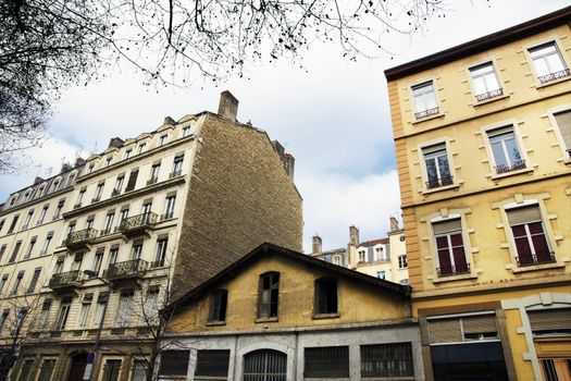 Very old abandoned little shop squeezed between two much larger apartment or flat buildings in Europe.