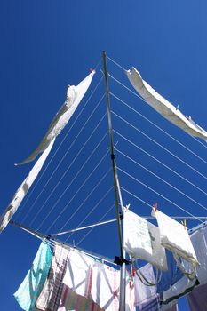 fresh washed laundry on rotary clothes dryer