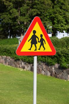 A warning road sign telling motorists that children may walk on the side of the road. A common sign in smaller communities with narrow roads in Sweden.