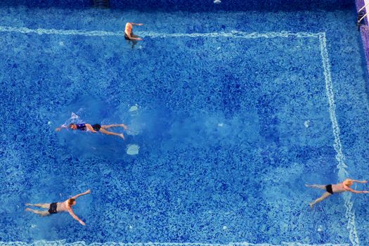 Fuerteventura, Canary Islands, Spain - February 18 2012. Four tourists on vacation are taking a swim in the swimmingpool of Hotel RIU Oliva Beach. The hotel is a very popular all-inclusive hotel. Every year 10.000 people visits the Canary Islands.
