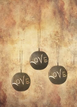 Three slate balls with the message love written by hand in chalk hanging freely, in grunge style.