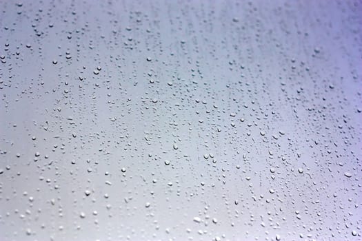 Drops of rain on the inclined window (glass). Shallow DOF.