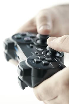 Male hands holding video game controller closeup