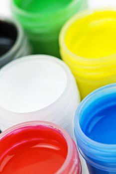 Open plastic containers of paint in primary colors