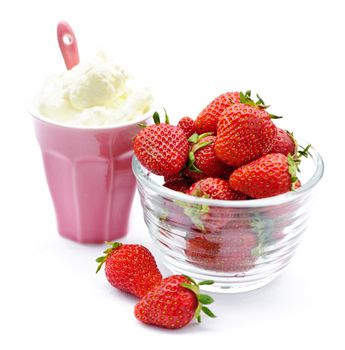 Bowl of fresh organic red strawberries with whipped cream