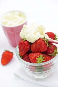 Bowl of fresh organic red strawberries with whipped cream