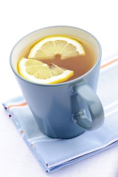 Cup of fresh hot tea with lemon slices