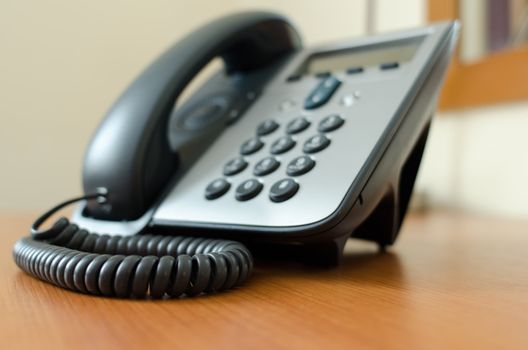 Telephone on a table with selective focus on front corner