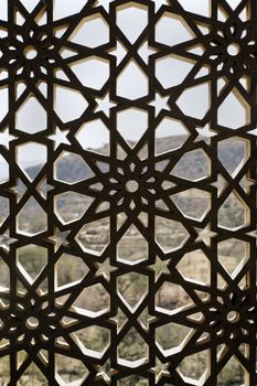 Indigenous concrete craftwork of Rajasthan India on a window opening, grid design allows air and light circulation but prevents the nesting of birds