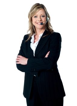 Portrait of happy female customer service executive with arms crossed, smiling at camera