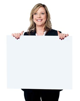 Female business professional showing blank clipboard to camera isolated on white