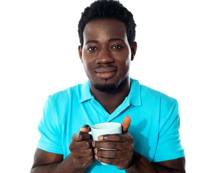 African guy holding coffee mug isolated over white background