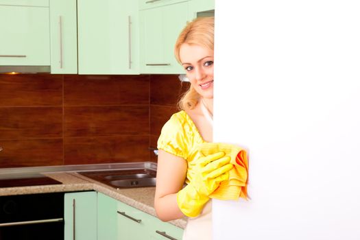 young attractive woman clean the kitchen ( green color )