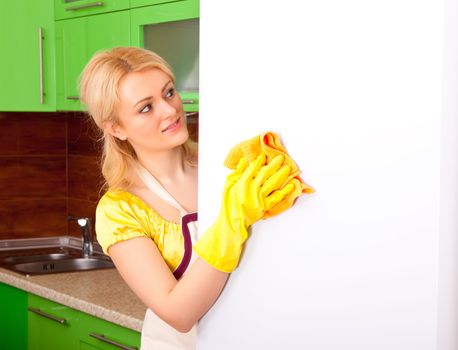 young attractive woman clean the kitchen ( green color )