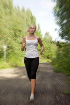 Girl with a music player running on the road