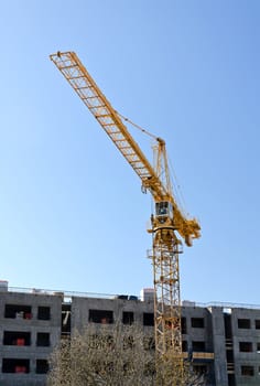 Tower crane near building under construction