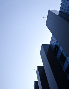 Office building under blue cloudless sky