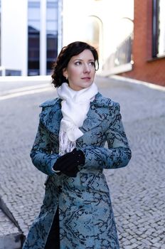 Portrait of a pretty girl with a scarf on the street