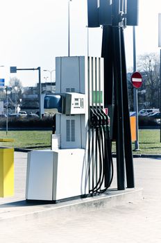 Pump nozzles at the gas station in the street