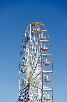 Ferris wheel against the blue sky