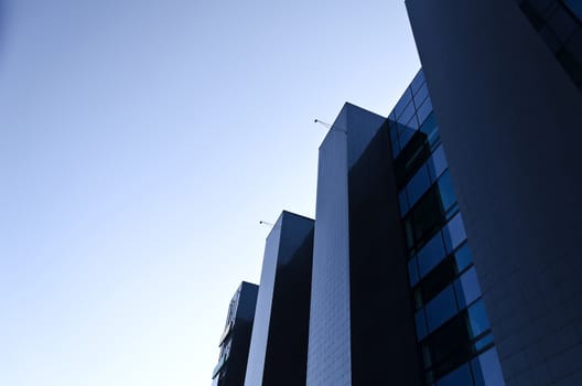 Office building under blue cloudless sky