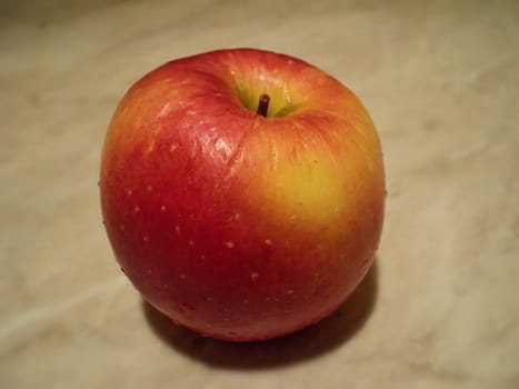 The general form of the red-yellow apple close-up, which is on the table