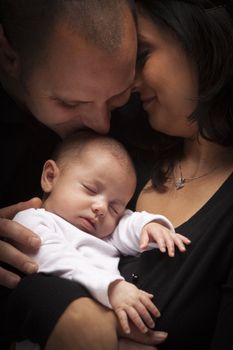 Happy Young Attractive Mixed Race Family with Newborn Baby.