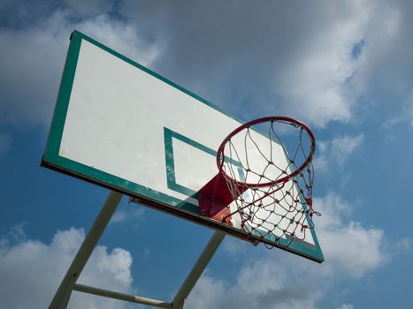 Green and white basketball hoop On the bright sky