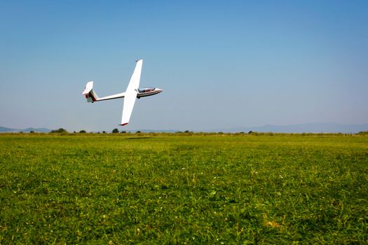 Glider flying on a blue sky