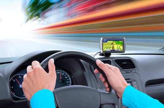 navigator on dashboard and hands of driver that sits on driver's seat