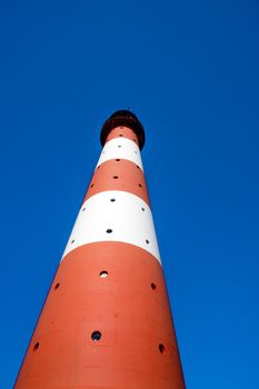 Vertical closeup of the lighthouse against a blue sky Westerhever in Germany