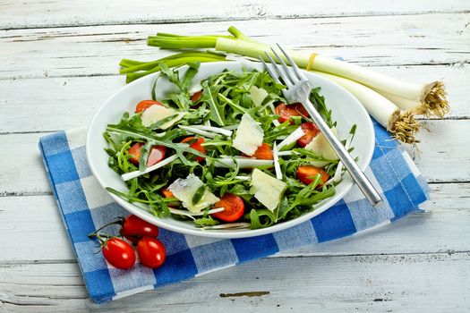 salad with arugula, cherry tomatoes, parmesan and shallot