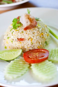 Closed up shrimp fried rice on the dish with vegetables.