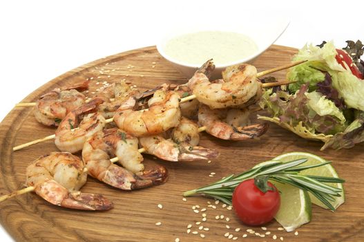 Grilled shrimp in a restaurant on a wooden platter