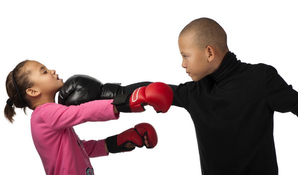 A boy punches a girl on the chin during a boxing contest.
