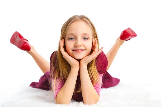 Happy girl lying on floor, isolated on white