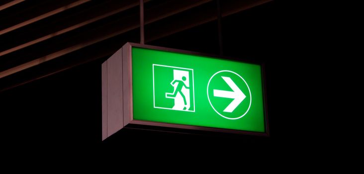 Emergency exit sign in modern offices inside an industrial plant