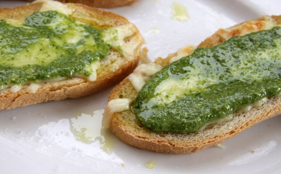 Delicious pesto and cheese toast, made with olive oil from the Liguria region of Italy.
