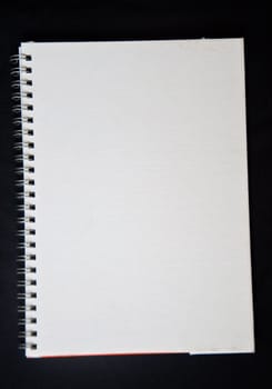 white notebook on black background