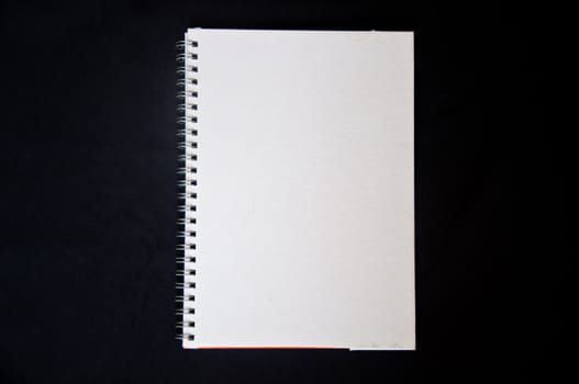 white notebook on black background