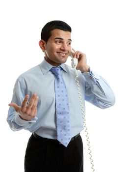 A smiling businessman in discussion conversation on the telephone.  White background.  