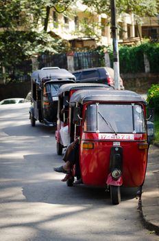 Kandy, Sri Lanka - December 8, 2011: Tuk-tuk is the most popular transport type on Asian streets.  .