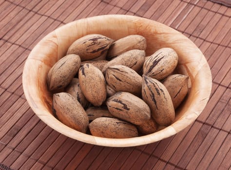 Bowl of pecan nuts, close up shot. 